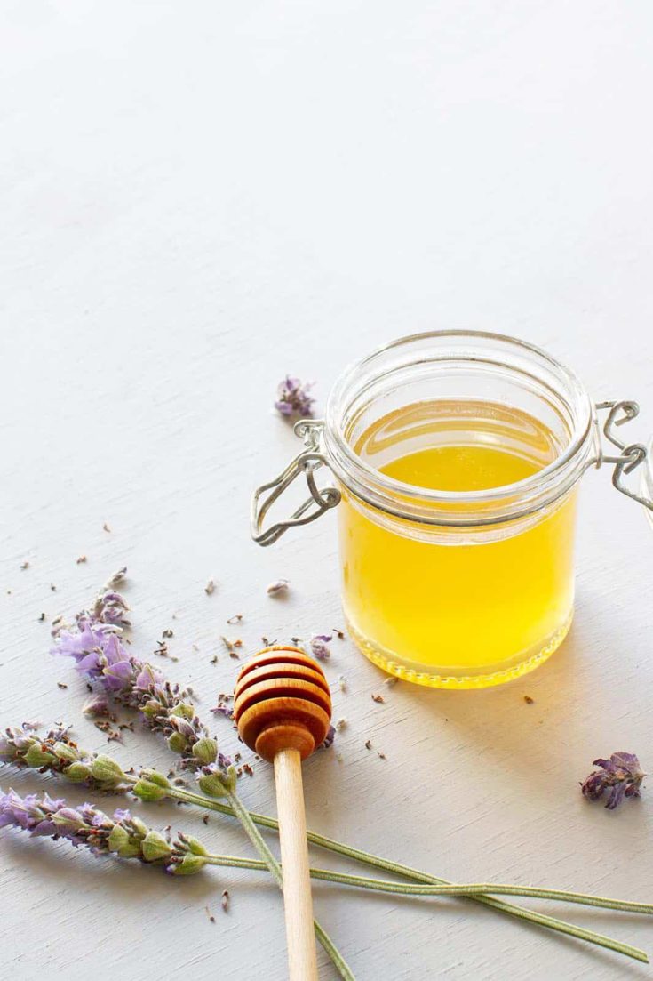 A glass jar of honey lavender syrup